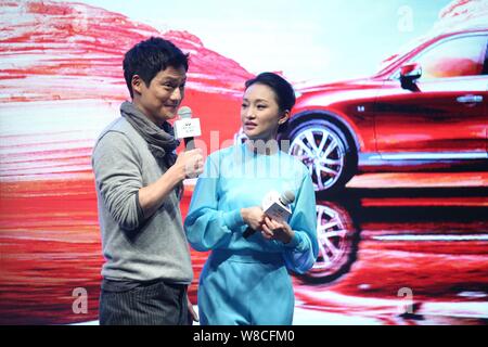 American actor Archie Kao, left, speaks next to his Chinese actress wife Zhou Xun  during a premiere event for the micro film 'Dream Escape' to promot Stock Photo