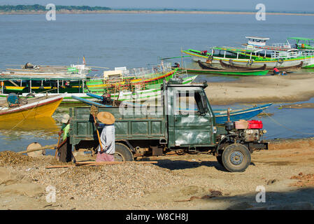 BAGAN, MYANMAR - DECEMBER 23, 2016: Loading a small truck in the river port of Bagan Stock Photo