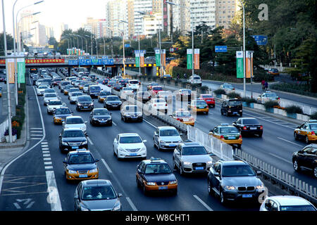 --FILE--Vehicles move slowly in a traffic jam on a road in Beijing, China, 13 November 2014.   In addition to pollution and congestion, the city of Be Stock Photo