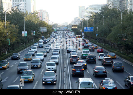 --FILE--Vehicles move slowly in a traffic jam on a road in Beijing, China, 13 November 2014.   In addition to pollution and congestion, the city of Be Stock Photo