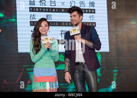 American singer Adam Lambert, right, and Chinese singer Zhang Liangying laugh during a press conference for the strategic cooperation between Billboar Stock Photo