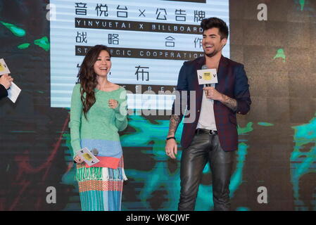 American singer Adam Lambert, right, and Chinese singer Zhang Liangying laugh during a press conference for the strategic cooperation between Billboar Stock Photo