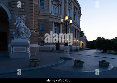 Ukraine, Odessa, Lanzheronivska street, 13th of June 2019. The entrance arch of the opera building at dawn with a big angel sculpture. Stock Photo