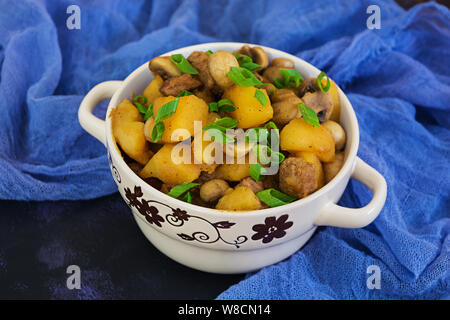 Stewed potatoes on dark background Stock Photo