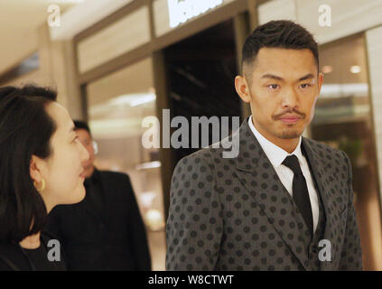 Chinese badminton star Lin Dan attends a signing event for his photo album in Beijing, China, 20 March 2015. Stock Photo
