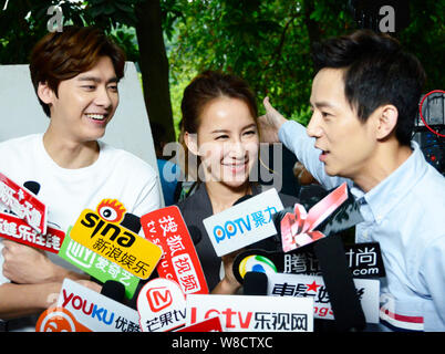 (From left) Chinese actor Li Yifeng, Taiwanese-American singer Coco Lee and Chinese director He Jiong are interviewed at the shooting scene of their n Stock Photo