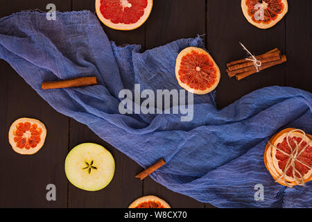 Apple, grapefruit and cinnamon on wooden background. Ingredient for hot mulled wine. Top view Stock Photo