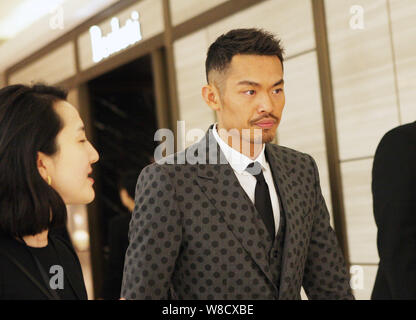 Chinese badminton star Lin Dan attends a signing event for his photo album in Beijing, China, 20 March 2015. Stock Photo