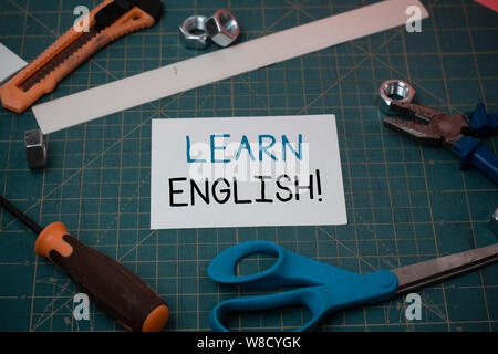 Handwriting text Learn English. Conceptual photo gain acquire knowledge in new language by study Carpentry equipments and plain paper scattered everyw Stock Photo