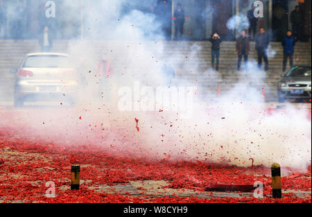 Firecrackers are launched on a street to celebrate the Chinese Lunar New Year in Zibo city, east China's Shandong province, 25 February 2015.   A tota Stock Photo