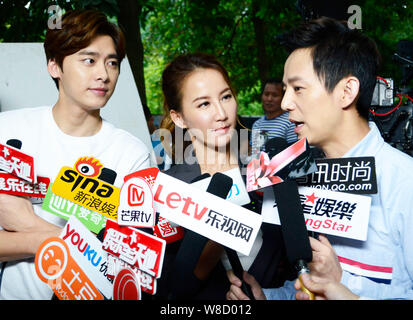 (From left) Chinese actor Li Yifeng, Taiwanese-American singer Coco Lee and Chinese director He Jiong are interviewed at the shooting scene of their n Stock Photo