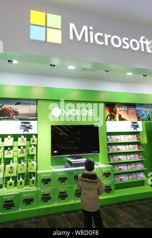 FILE--A young boy plays electronic games on an XBOX ONE game console at a  physical store of Microsoft in Shanghai, China, 26 December 2014. Produc  Stock Photo - Alamy