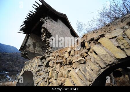 An old temple hangs half in the air after its foundation sank in Niujiakou village in Taiyuan city, north China's Shanxi province, 6 February 2015. Stock Photo