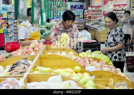 --FILE--Chinese customers shop for fruits at a supermarket in Liaocheng city, east China's Shandong province, 9 August 2015.   Until recently, the eas Stock Photo