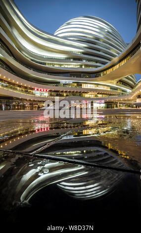 Night view of the Galaxy Soho developed by Soho China in Beijing, China, 31 March 2014. Stock Photo