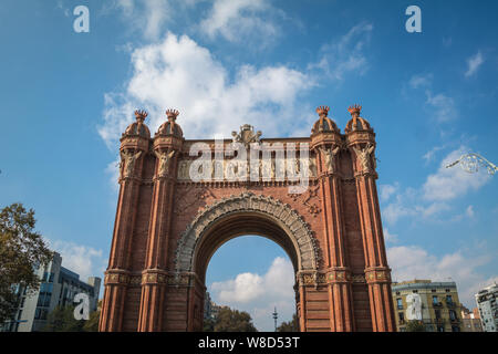 The red brick Arc de Triomf (Arc de Triomphe) and blue sky in Barcelona Stock Photo