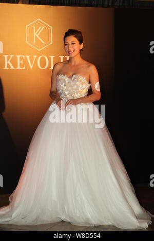 Hong Kong actress Mandy Wong poses at the opening ceremony for actress Myolie Wu's 'Kevolie' wedding dress shop in Hong Kong, China, 10 August 2015. Stock Photo