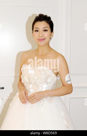 Hong Kong actress Mandy Wong poses at the opening ceremony for actress Myolie Wu's 'Kevolie' wedding dress shop in Hong Kong, China, 10 August 2015. Stock Photo