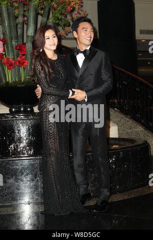 Hong Kong actor Kenny Bee, right, and his wife Fan Jiang pose as they arrive for their wedding party in Hong Kong, China, 22 May 2015. Stock Photo