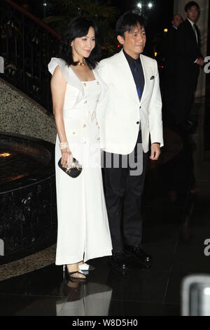 Hong Kong actress Carina Lau, left, and her actor husband Tony leung chiu wai, pose as they arrive for the wedding party of Hong Kong actor Kenny Bee Stock Photo