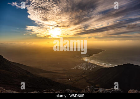 Amazing summer sunset over ocean resort beach Famara Lanzarote Canary Islands, Spain Stock Photo