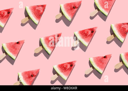 Sliced watermelons arranged on a pink background Stock Photo