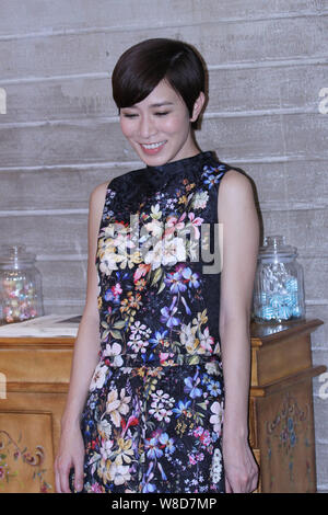 Hong Kong actress Charmaine Sheh smiles during a press conference for new creations of OASIS in Shanghai, China, 18 May 2015. Stock Photo