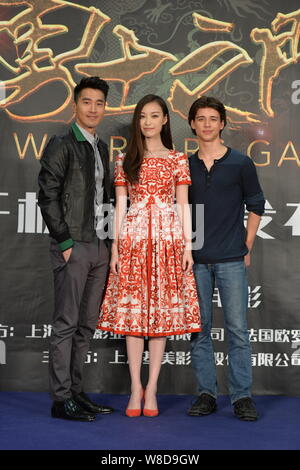 Chinese actress Ni Ni, center, and Taiwanese actor Mark Zhao, left, pose during a press conference for their new movie 'Warriors Gate' in Beijing, Chi Stock Photo