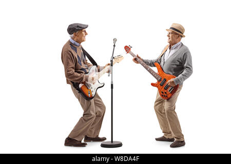 Full length shot of two elderly men having a jam session with electric guitars isolated on white background Stock Photo