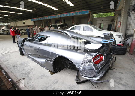 The Koenigsegg Agera R supercar which was seriously damaged in a road crash is parked at a garage in Chongqing, China, 29 Novemebr 2015.   A driver sp Stock Photo