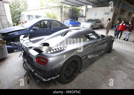 The Koenigsegg Agera R supercar which was seriously damaged in a road crash is parked at a garage in Chongqing, China, 29 Novemebr 2015.   A driver sp Stock Photo