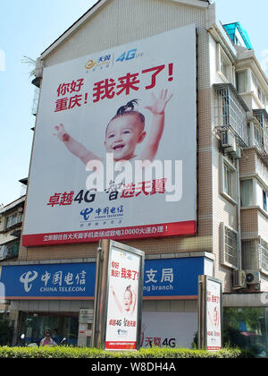 --FILE--View of a branch of China Telecom with an advertisement for the Tianyi Surfing 4G LTE of China Telecom in Chongqing, China, 23 July 2014. Stock Photo