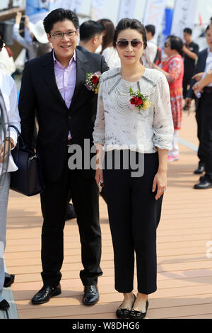 Kenneth Fok Kai-kong, eldest son of Hong Kong tycoon Timothy Fok Tsun-Ting, left, and his wife, Chinese Olympic diving champion Guo Jingjing, pose dur Stock Photo