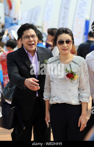 Kenneth Fok Kai-kong, eldest son of Hong Kong tycoon Timothy Fok Tsun-Ting, left, and his wife, Chinese Olympic diving champion Guo Jingjing, pose dur Stock Photo