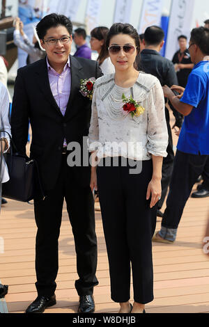 Kenneth Fok Kai-kong, eldest son of Hong Kong tycoon Timothy Fok Tsun-Ting, left, and his wife, Chinese Olympic diving champion Guo Jingjing, pose dur Stock Photo