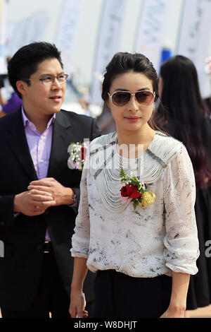 Kenneth Fok Kai-kong, eldest son of Hong Kong tycoon Timothy Fok Tsun-Ting, left, and his wife, Chinese Olympic diving champion Guo Jingjing, pose dur Stock Photo