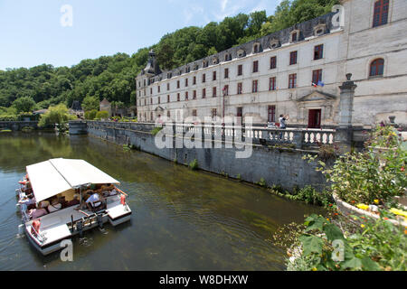 Brantome en Perigord, France. Picturesque view of a tourist boat transiting the River Dronne, with the Abbey of Brantome on the right of the image. Stock Photo