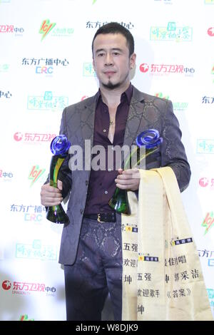 Chinese singer Yang Kun poses with his trophies during the 22th Oriental Billboard Awards ceremony in Shanghai, China, 30 March 2015. Stock Photo