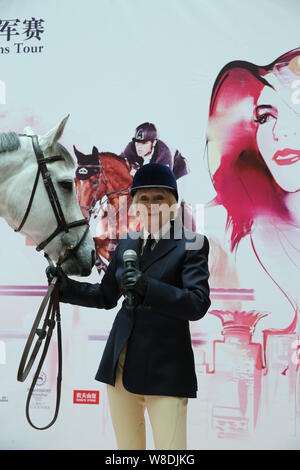 British etiquette expert Diana Mather kisses a horse at an equestrian exhibition at CITIC Pacific Plaza ahead of the 2015 Shanghai Longines Global Cha Stock Photo