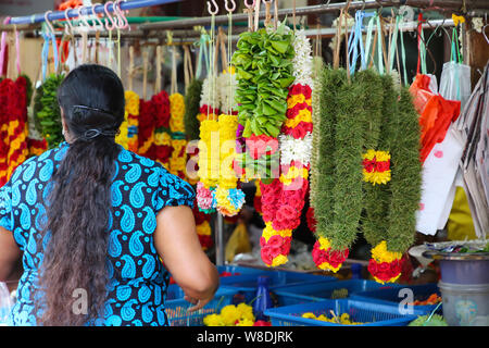 Woman selling flowers on the street in Little India Singapore Stock Photo