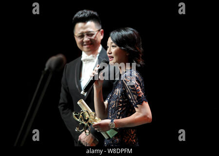 Chinese actress Zhou Xun, right, speaks after winning the Best Actress award at the closing ceremony for the 21th Shanghai Television Festival in Shan Stock Photo