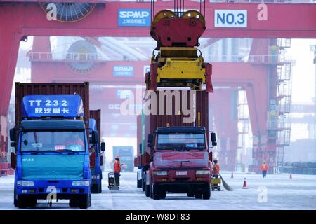 Containers are being lifted on a quay at the Port of Qingdao in Qingdao city, east China's Shandong province, 8 February 2015.   China registered its Stock Photo