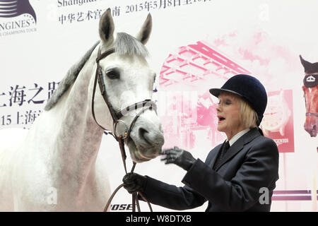 British etiquette expert Diana Mather poses with a horse at an equestrian exhibition at CITIC Pacific Plaza ahead of the 2015 Shanghai Longines Global Stock Photo