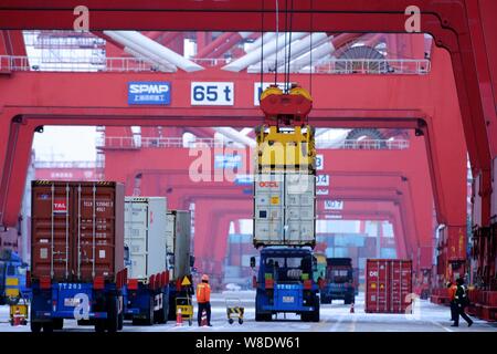 Containers are being lifted on a quay at the Port of Qingdao in Qingdao city, east China's Shandong province, 8 February 2015.   China registered its Stock Photo
