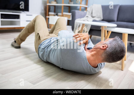 Man Fallen On Floor Having Pain Lying On Floor After Accident Stock Photo