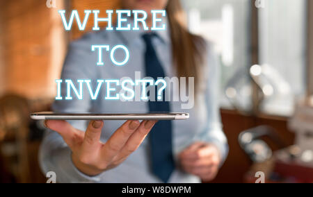 Word writing text Where To Invest question. Business photo showcasing asking about actions or process of making more money Blurred woman in the backgr Stock Photo
