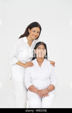Old woman sitting with her mature daughter Stock Photo