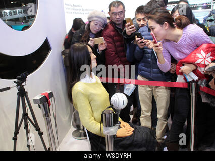 Visitors take photos of the humanoid robot 'Robot Geminoid F (female)', produced by renowned robot designer Hiroshi Ishiguro of Osaka University, duri Stock Photo