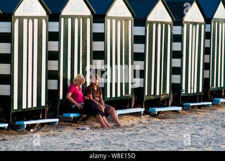 colorful and vintage beach cabins resting all summer on the sand of the beach in De Panne, Belgium Stock Photo