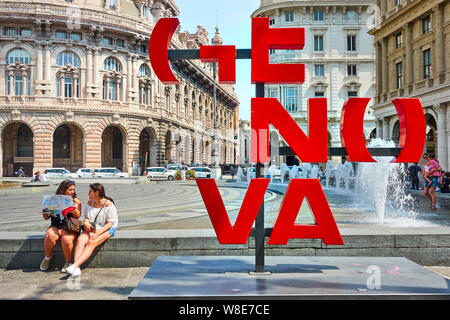 Genoa , Italy - July 7, 2019: Genova More Than This sign (City Logo) and tourists nearby in De Ferrari square in Genoa Stock Photo